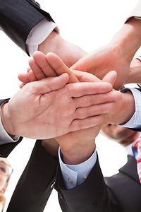 Symbolic picture of hands placed on top of each other